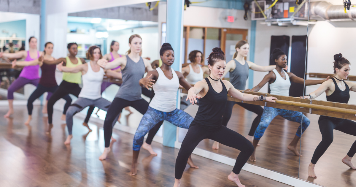 GROUP OF LADIES DOING BARRE WORKOUTS