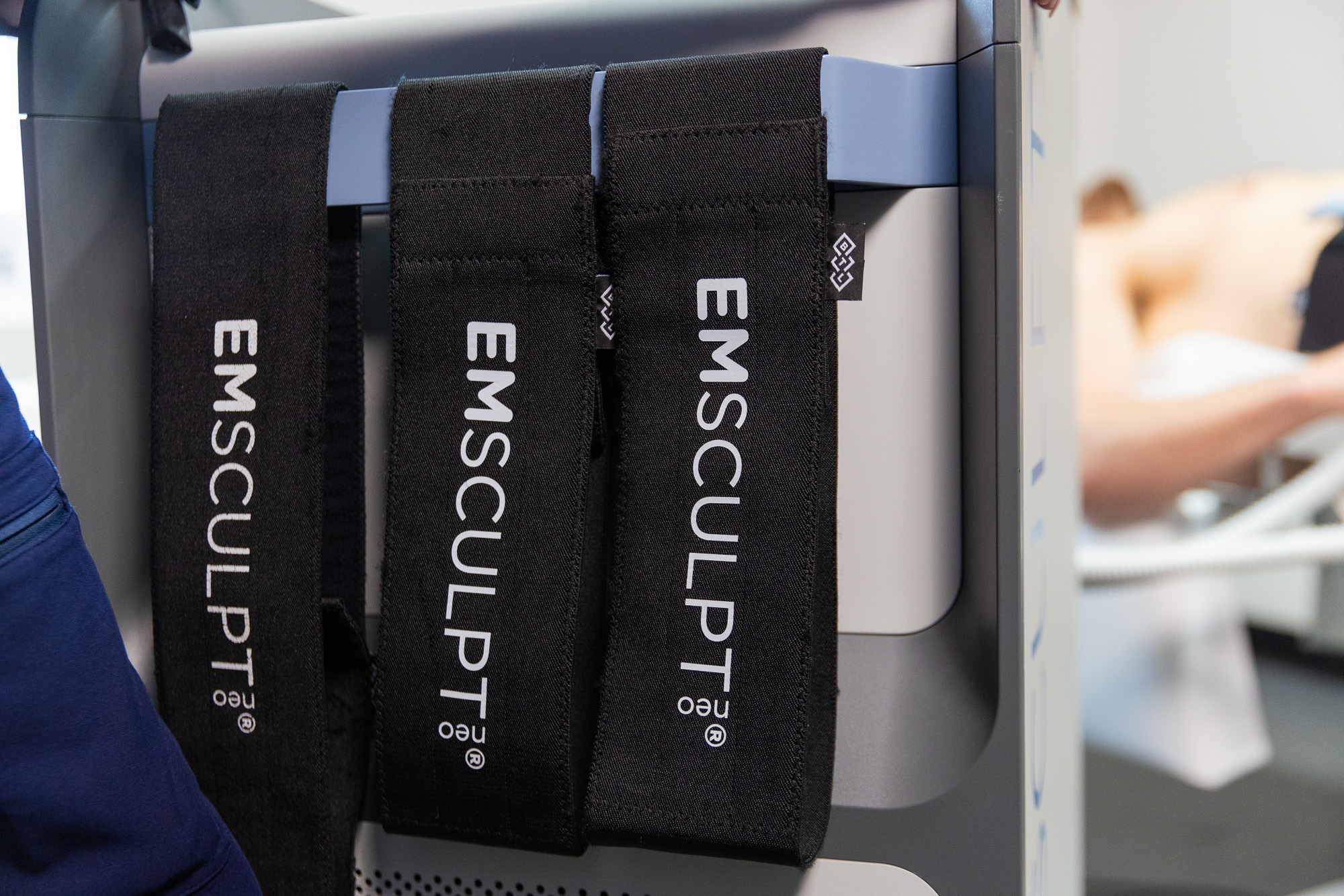 The bands and applicator rest on the side of the workstation for Emsculpt NEO near Fairfax.