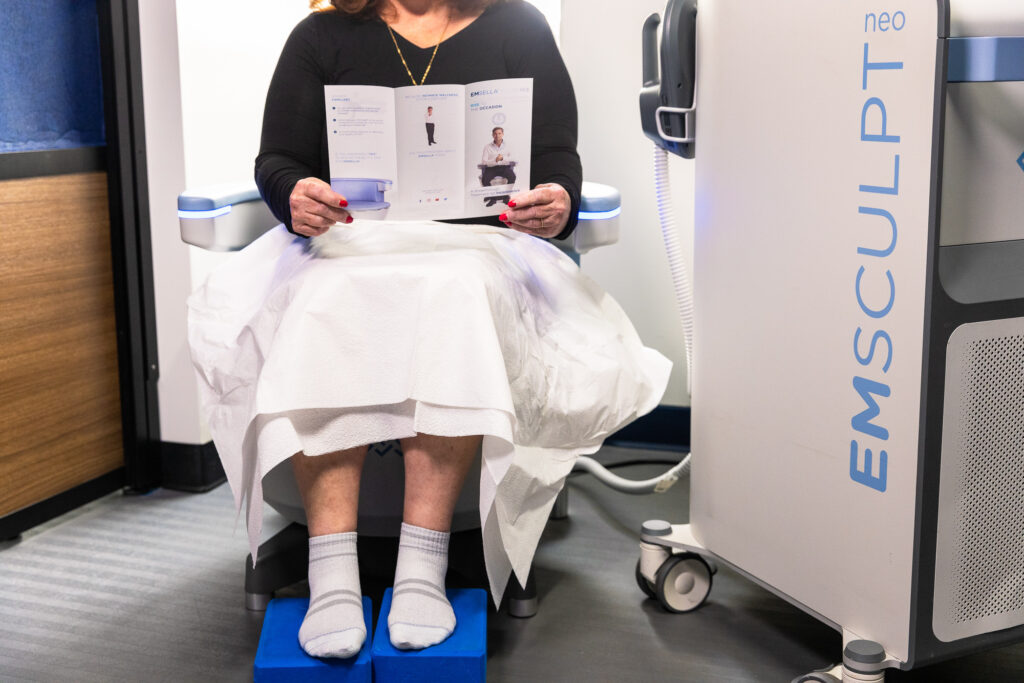 A client sits on the Emsella chair that treats stress incontinence near Arlington, VA.