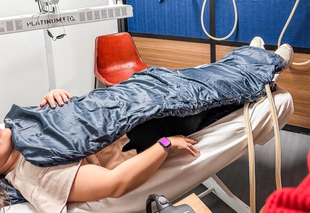 A client lies down using PEMF therapy for pain management in Alexandria.